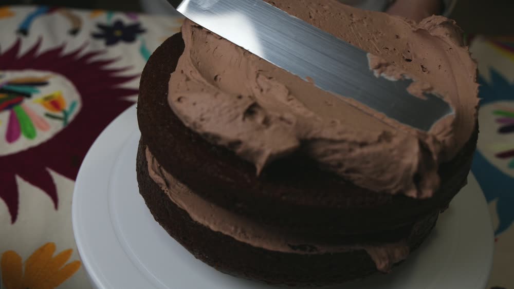 K-Frost frosting spread on a chocolate cake